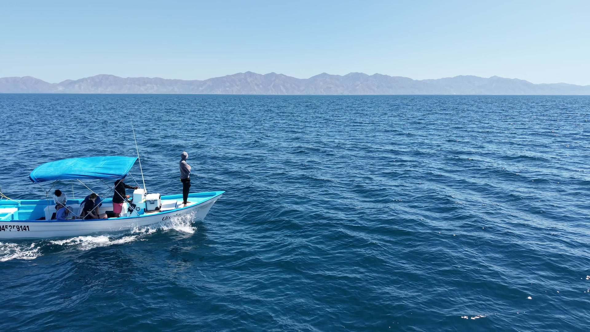 Aerial wide shot of a Bajablue boat heading out toward Cerralvo Island in the Sea of Cortez